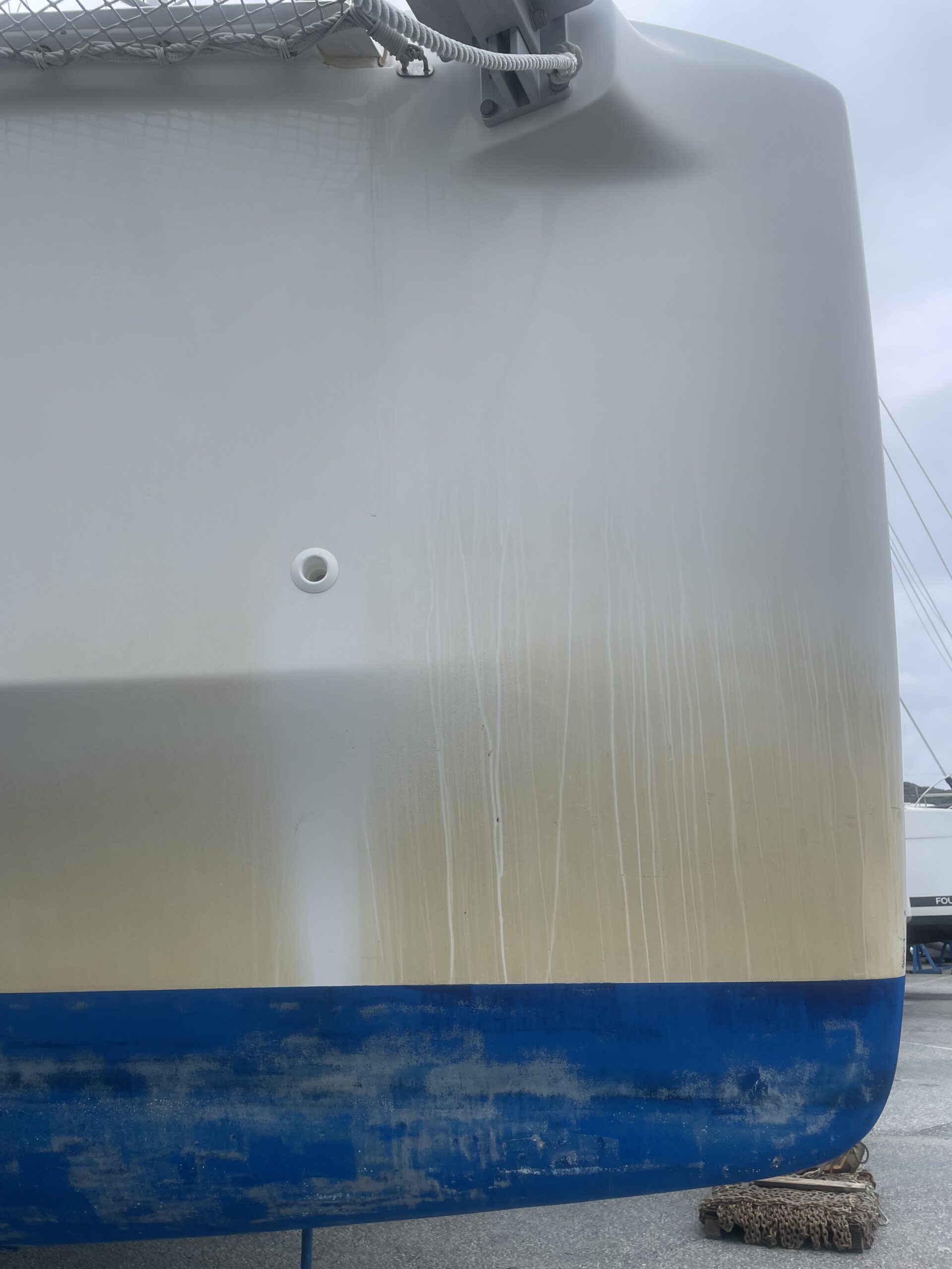 Boat hull showing gelcoat yellowing due to UV exposure and marine environment