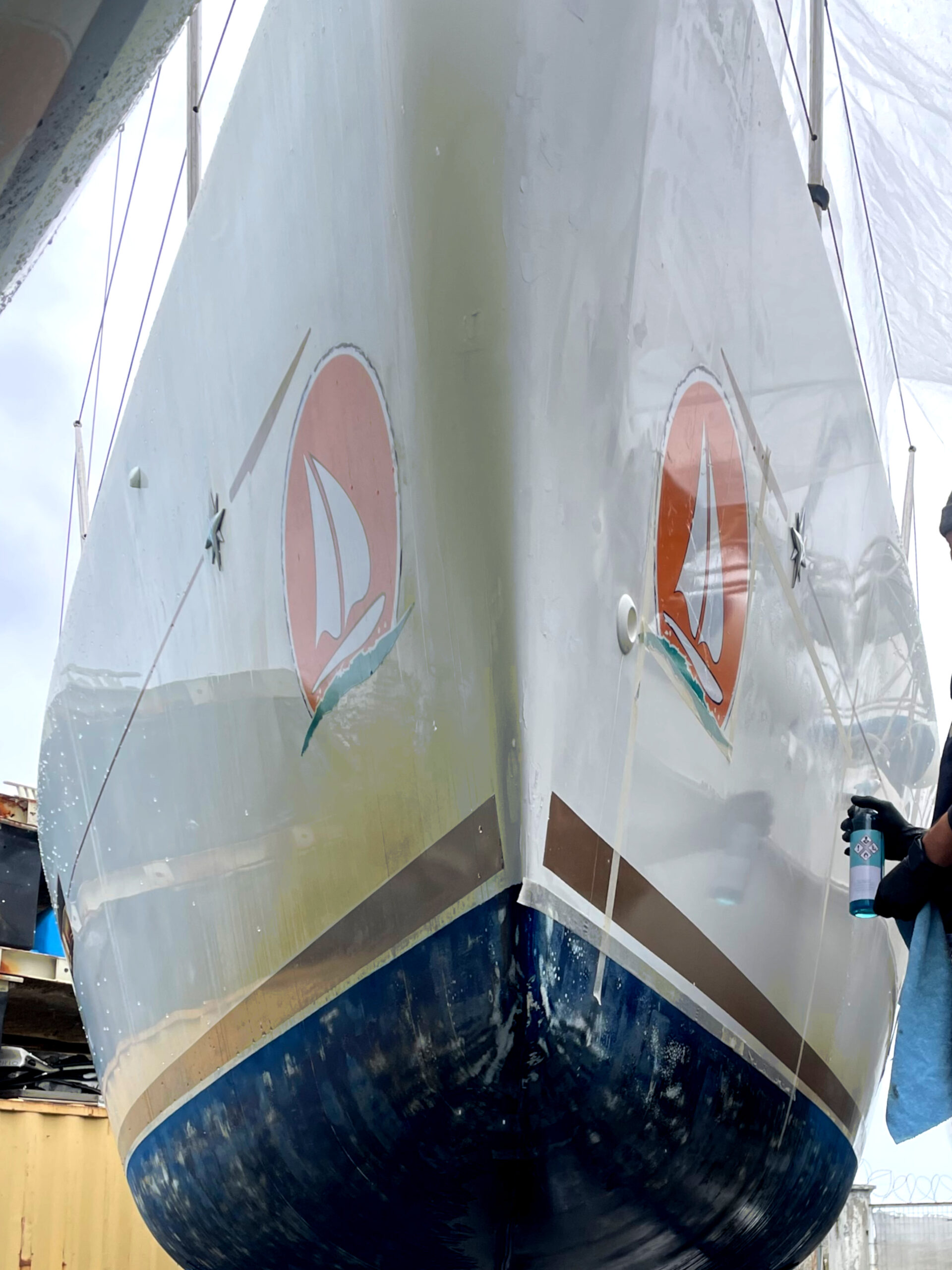 Boat hull comparison showing gelcoat yellowing on the left and SEALS-treated clean surface on the right